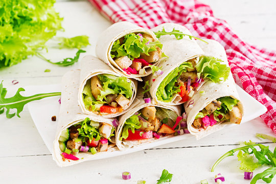 Chicken burrito. Healthy lunch.  Mexican street food fajita tortilla wraps with grilled  chicken fillet and fresh vegetables.