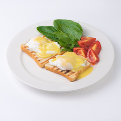 Plate of breakfast with fried eggs, toasts, tomato isolated on white backgound