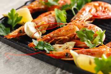 Grilled shrimps with spice, garlic and lemon. Grilled seafood. Langoustines.