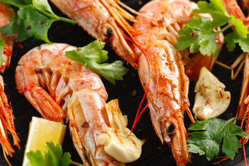Grilled shrimps with spice, garlic and lemon. Grilled seafood. Langoustines.