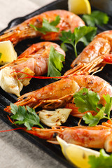 Grilled shrimps with spice, garlic and lemon. Grilled seafood. Langoustines.