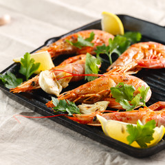 Grilled shrimps with spice, garlic and lemon. Grilled seafood. Langoustines.