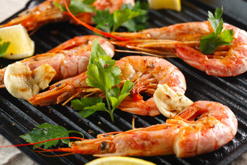 Grilled shrimps with spice, garlic and lemon. Grilled seafood. Langoustines.