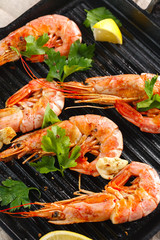 Grilled shrimps with spice, garlic and lemon. Grilled seafood. Langoustines.