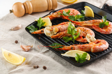 Grilled shrimps with spice, garlic and lemon. Grilled seafood. Langoustines.