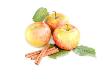 Apples with leaves and cinnamon sticks isolated on white background.