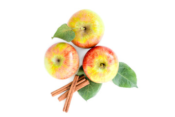 Apples with leaves and cinnamon sticks isolated on white background.