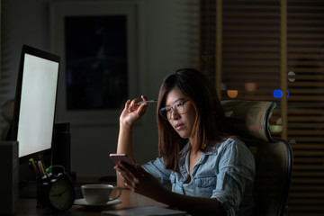 Portrait of Asian Businesswoman sitting and working hard on the table with front of computer...