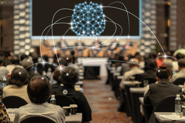 Brainstorming concept of Rear view of Audience listening Speakers on the stage in the conference...
