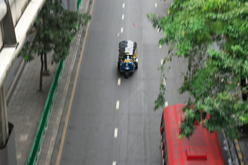 Bangkok,Thailand-December 8, 2018: Panning of Tuk Tuk running at Silom street near Patpong in Bangkok
