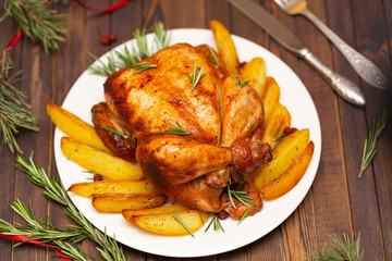 Roasted whole chicken with Christmas decoration. Wooden background.