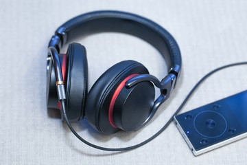modern headphones near mp3 player