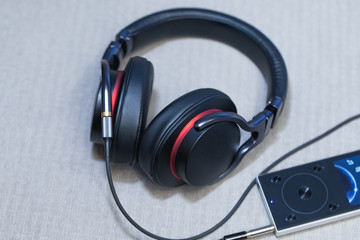 modern headphones near mp3 player