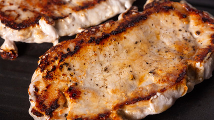 Frying tho pieces of pork chop on a grilling pan