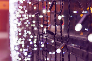 Garlands close-up. Christmas lights with bokeh. Garlands on New Year window