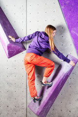 Awesome woman climbing indoor long hair violet volumes