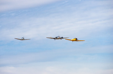 squadron of old planes flying in an air show