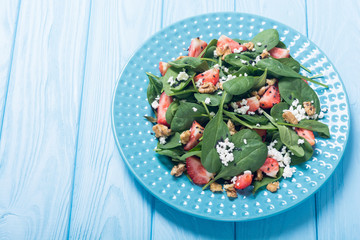 Strawberry salad with spinach , cheese and walnut . Healthy food