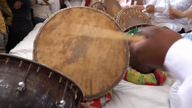 Man playing on a drum on time Pushkar Camel Mela near holy city Pushkar, Rajasthan, India, close up. Drums hands, movement, rhythm