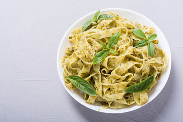 Pasta tagliatelle with green sauce pesto . Italian food background