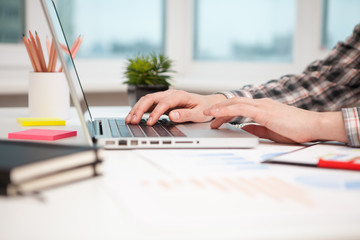 Close Up of businessman hands using laptop computer