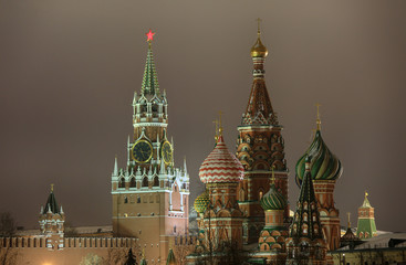 Beautiful night view of the Spasskaya Tower of the Moscow Kremlin and the dome of St. Basil's Cathedral in Moscow