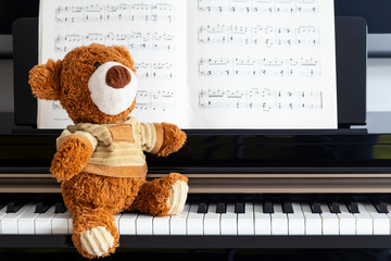 Piano keys music sheets and Teddy bear