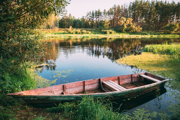 Old Wooden Rowing Fishing Boat Near Lake River Coast At Beautifu