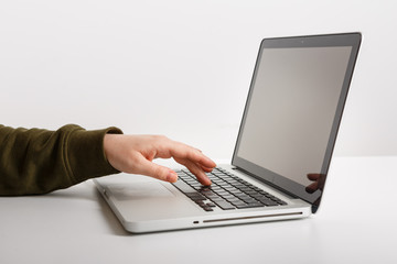 Laptop with woman hand isolated