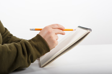 Female hands with pen writing and working notebook