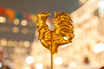 Cockerel candy on a stick. Hard candy rooster. Rooster candy symbol © Ruslan Gilmanshin