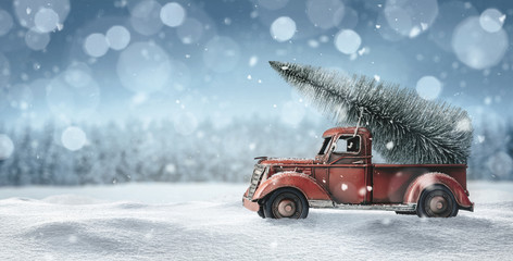 Old red toy truck with christmas tree loaded on the back - Powered by Adobe