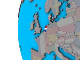 Netherlands with national flag on blue political 3D globe.