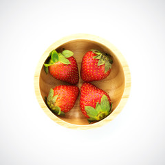 Sweet strawberry in wooden plate on a white background.
