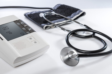 stethoscope on white table with syringe