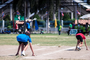 Rear view of girl students ready to run on running track on a sport day