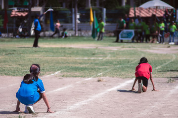Rear view of girl students ready to run on running track on a sport day