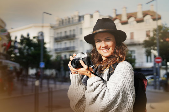 Good looking brunette photographer with vintage camera in city