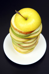 Sliced ​​apple in a pyramid on a white plate