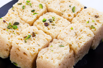 Indian Traditional Famous Sweet Food Mysore Pak or Mysoor Pak Isolated on White Background