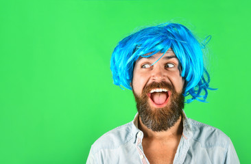 Funny bearded man wearing blue wig. Handsome bearded man with stylish mustache in wig. Fashion, art...