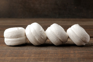 Sweet white round marshmallow on a brown wooden table. Sweets. dessert.