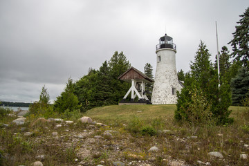 Fototapeta na wymiar Haunted Michigan Lighthouse. Built in 1840, the old Presque Isle Lighthouse is reportedly haunted. Legend says the beacon continues to shine even though the light was decommissioned decades ago. 