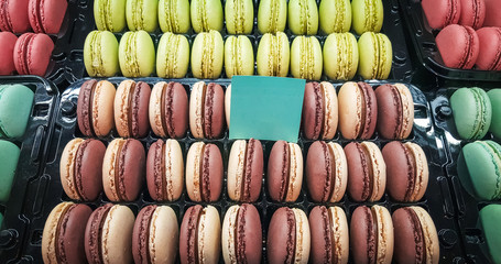 Assortment of macarons in a plastic container on sale in a patisserie