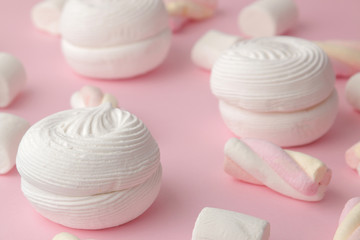 Fototapeta na wymiar Background of sweet white marshmallows and small marshmallows on bright trendy pink background. Sweets. dessert.