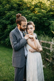 Bride embracing groom on a meadow