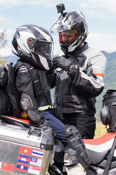 Father and son having a break during a motorbike trip