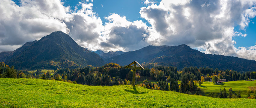 Germany, Bavaria, Allgaeu, Allgaeu Alps, Oberstdorf, Cross in the Oy Valley, Stillach Valley in the background