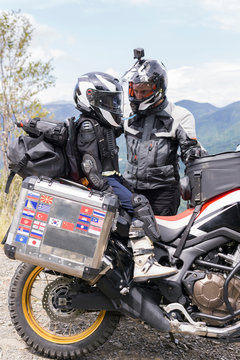 Father and son having a break during a motorbike trip