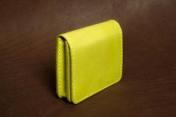 wallet yellow on a brown background